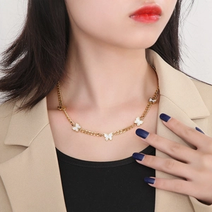 Elegant gold titanium steel necklace featuring five white butterfly pendants on flat cuban link chain