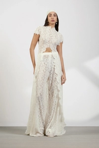 Close-up of intricate white lace pattern on bohemian two-piece top and pants set