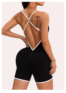 Detail showing cross-back design and white piping on ribbed black yoga bodysuit