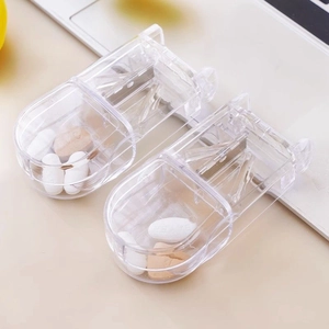 Transparent pill cutter with V-shaped slot and metal blade for precise tablet splitting