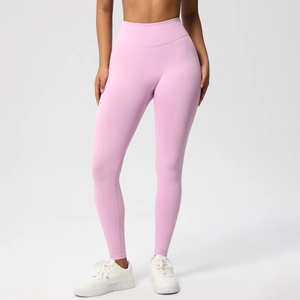 Detail of high-waist seamless yoga pants with ribbed waistband in soft pink fabric