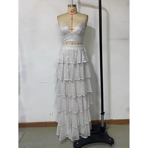 Detail view of the white sequin crop top and multi-layered ruffled long skirt on a mannequin