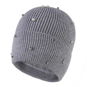 Gray knitted beanie for women with silver pearls and warm fleece lining shown at 45 degrees