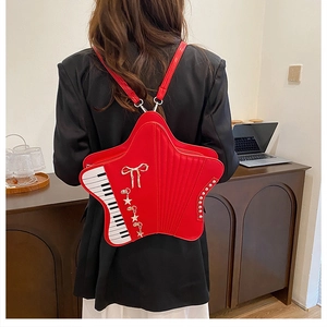 Detailed view of the red star-shaped backpack with piano key design on model's back