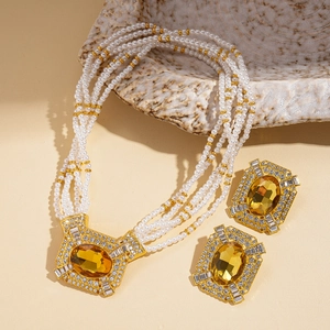 Multi-layer pearl necklace and earrings set with amber gemstone and gold accents