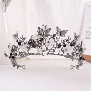 Detailed macro view of white flower petals and silver butterfly on the crystal bridal crown