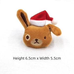 Macro detail of Christmas bear plush brooch measuring 6.5cm height with red Santa hat