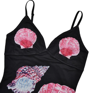 Detail of V-neck camisole dress featuring colorful seashell patterns on a black base