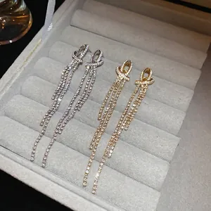 Knot bow tassel drop earrings with sparkling rhinestones in gold and silver plating
