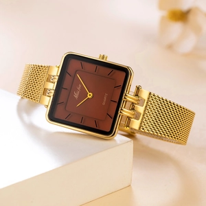 Detail showing the square gold-tone quartz watch with dark brown dial and mesh strap
