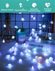 Close-up of natural crystal LED string lights styled with candles for home ambiance