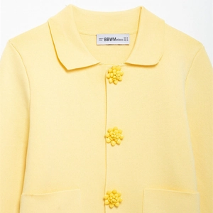 Bright yellow knit cardigan featuring a lapel collar and floral shaped buttons