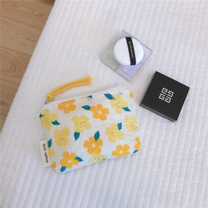 Macro detail of floral cotton coin purse with zipper and simple wish woven label
