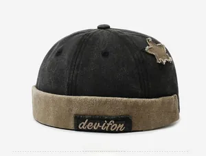 Detail of vintage patchwork docker hat with star patch and devifon embroidery
