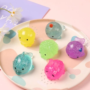 Set of 6 glittery animal squishy toys including octopus and dolphin in a pastel tray