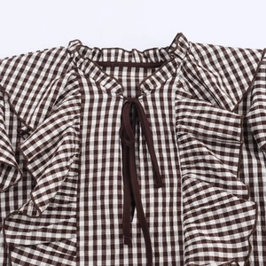 Plaid long-sleeve blouse with ruffled collar and drawstring details in brown and white