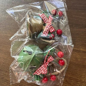 Detail of vintage Christmas bells with pine needles, berries, and hemp rope hangers