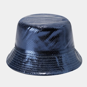 Detail of bright blue metallic bucket hat featuring a fine laser grid textured surface