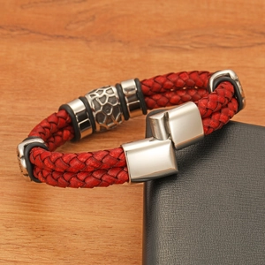 Detail of red double-layered braided leather bracelet with silver textured metal bead