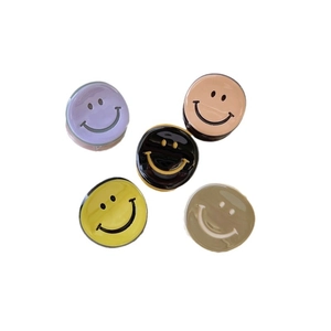 Five colorful acetate smiley face mini hair clips in purple yellow beige and black