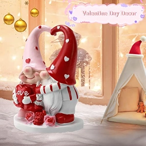 Detail of resin Valentine's Day gnomes with love heart and pink roses on a white base