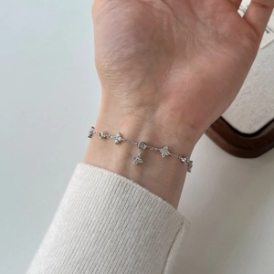 Elegant 925 sterling silver four-leaf clover bracelet with sparkling cubic zirconia stones
