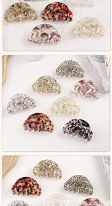 Detail of shell-shaped acetate hair claws in various vintage marble and tortoiseshell patterns
