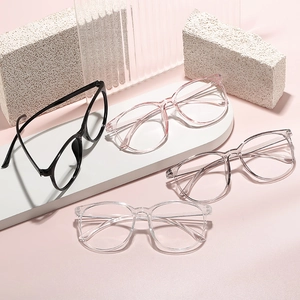 Fashionable oversized blue light blocking glasses in four colors on a white display stand