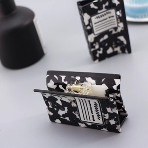 Detail of acetate hair claws featuring black and white marble patterns and text print
