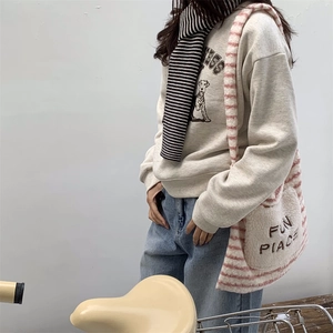 Fuzzy faux fur crossbody bag with pink stripes and FUN PLACE embroidery on a casual outfit