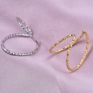 Detailed close-up of adjustable double-layer rings with gold and silver quilted textures