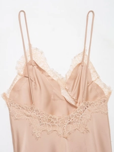 Detailed view of champagne satin dress with delicate eyelash lace and slim straps
