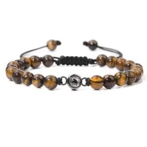 Detailed shot of brown tiger eye stone beads and black adjustable braided cord bracelet