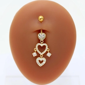 Golden heart-shaped belly ring with clear cubic zirconia dangles shown on body