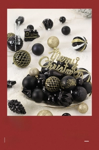Detailed set of black and gold Christmas ornaments including train and Merry Christmas sign