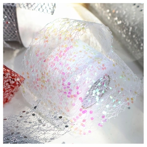 Close-up of white chiffon mesh ribbon with sparkling pink and purple sequins for decor