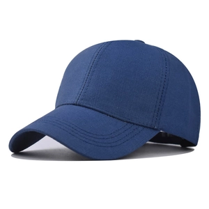 Detail of dark blue cotton baseball cap showing six-panel structure and stitched brim