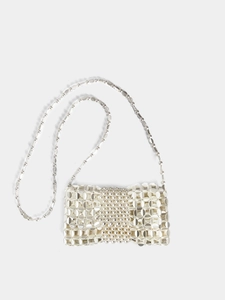Detail of silver woven chain crossbody bag with pearl embellishments and metallic texture