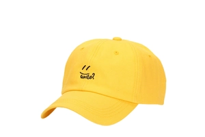 Close-up of yellow cotton baseball cap featuring black smile face embroidery details