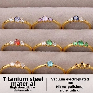 Macro detail of nine titanium steel rings with colorful gems in a jewelry display box