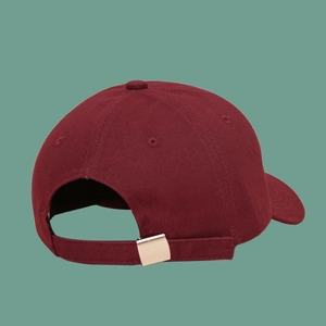 Detail of burgundy cotton baseball cap back with adjustable metal buckle and strap