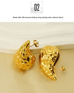 Detail of 18K gold-plated teardrop earrings with hammered texture on a display