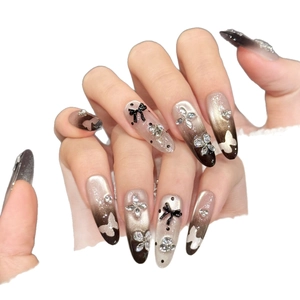 Brown gradient almond press-on nails with 3D butterfly bows and rhinestone accents