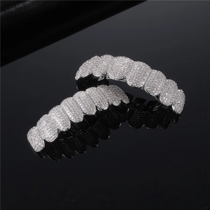 Silver iced out hip hop grills set with sparkling stones on black background