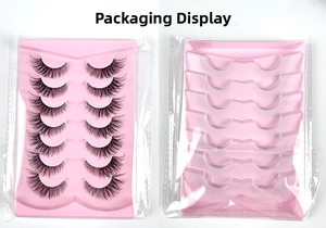 Detail view of 7 pairs of fox-eye false eyelashes in pink tray and transparent packaging