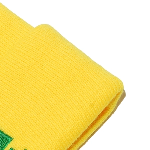 Close-up of lemon yellow ribbed knit beanie with green embroidery and soft texture