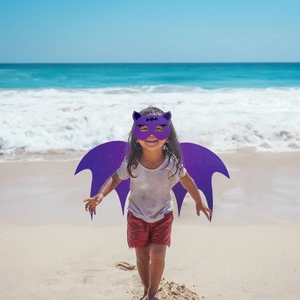 Kids purple bat wings and mask set for Halloween cosplay party in sunny beach scene