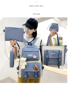 Detailed five-piece blue and white canvas backpack set with plush bear and pins
