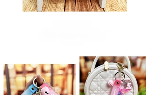 Detail of pink and blue unicorn liquid charms with matching lanyard and bells on a white bag