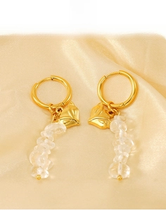 Detail view of gold titanium steel fox pendant earrings with clear crushed natural stones